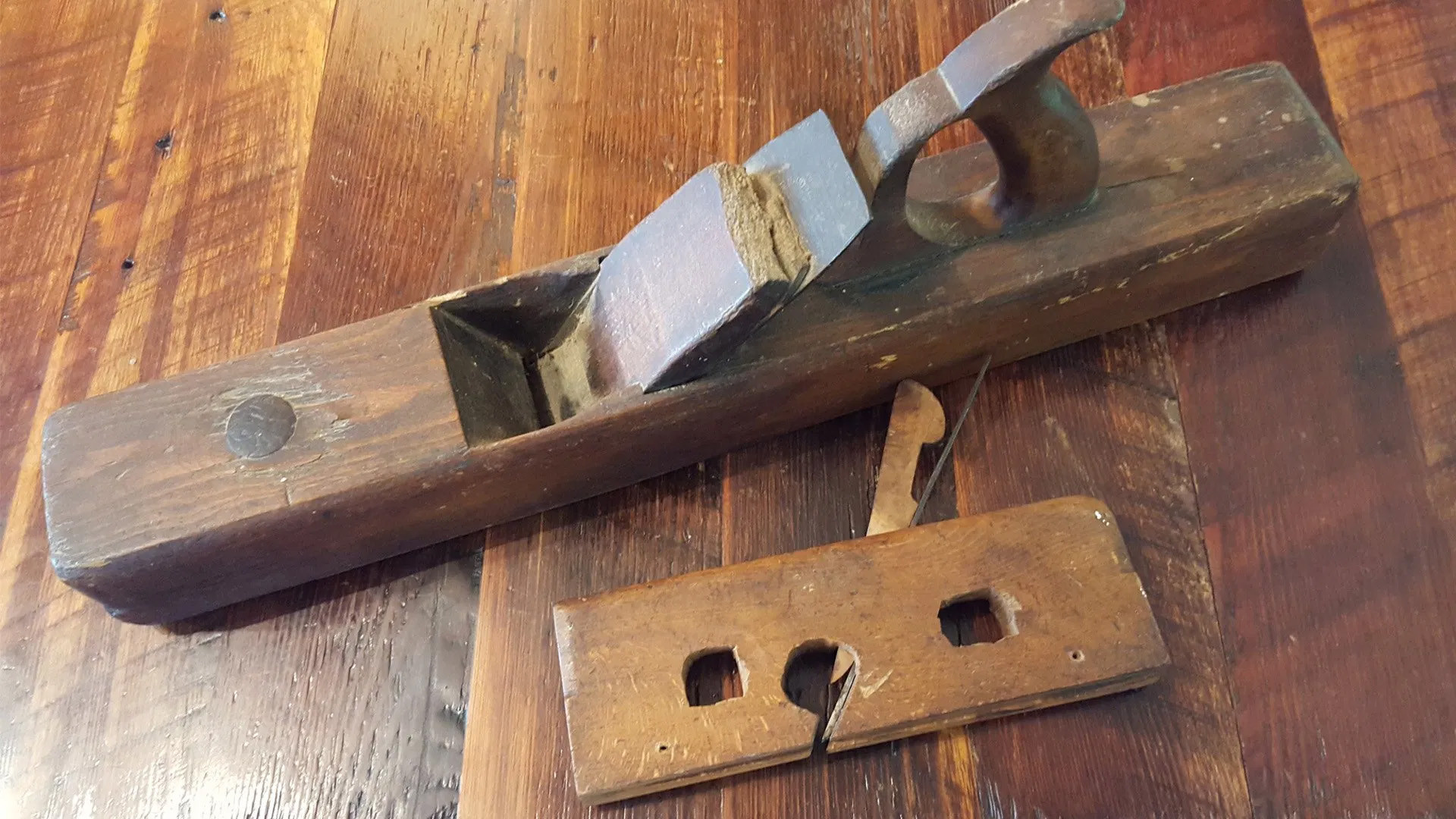vintage hand planer on a background of antique  heart pine milled flooring.