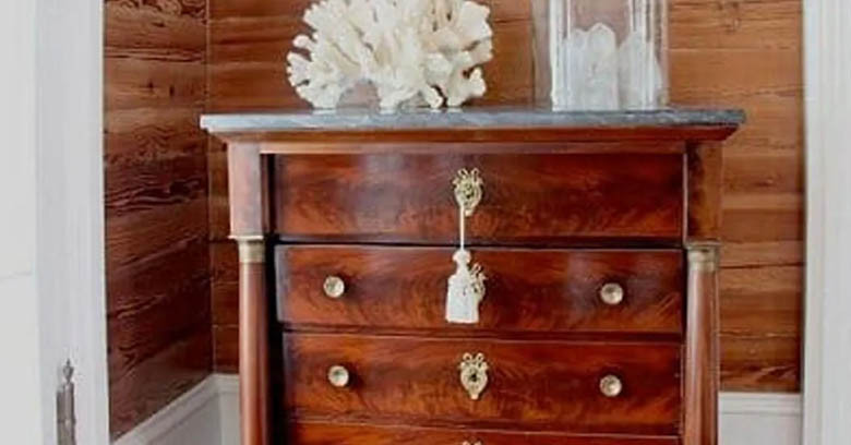 Dade county pine wall surround a vintage bureau.