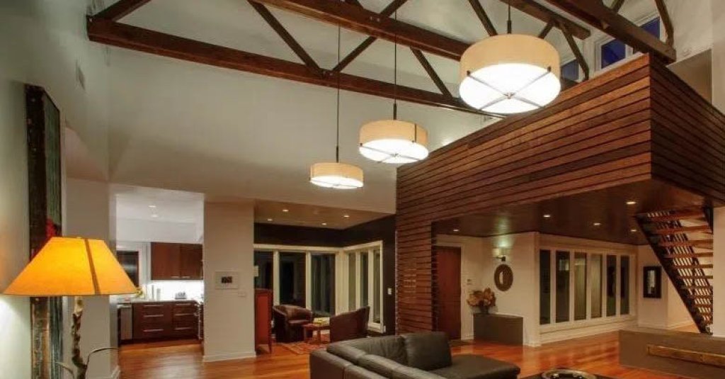 Modern wood home with antique heart pine flooring and wall paneling details.