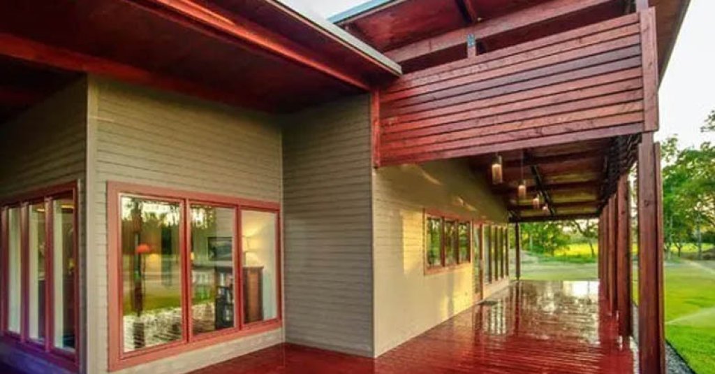Modern wood home with antique heart pine porch floors and wall panels.