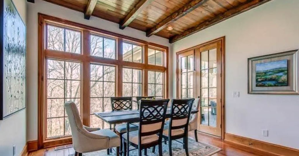 This dining room is inspired by the work of A. Hays Town with pine beams and solid cypress windows.