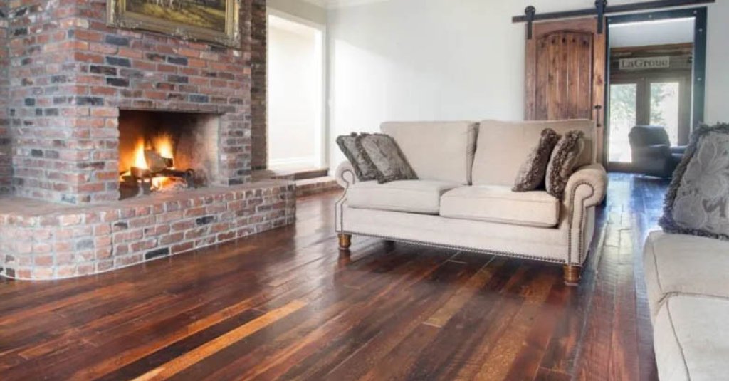 A cozy living room with roaring brick fireplace and Orleans Collection flooring from Albany Woodworks.