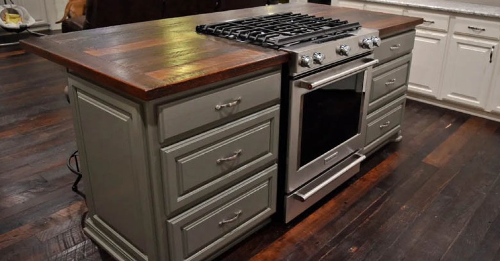 A rustic "dirty top" kitchen island and flooring Orleans Collection by Albany Woodworks.